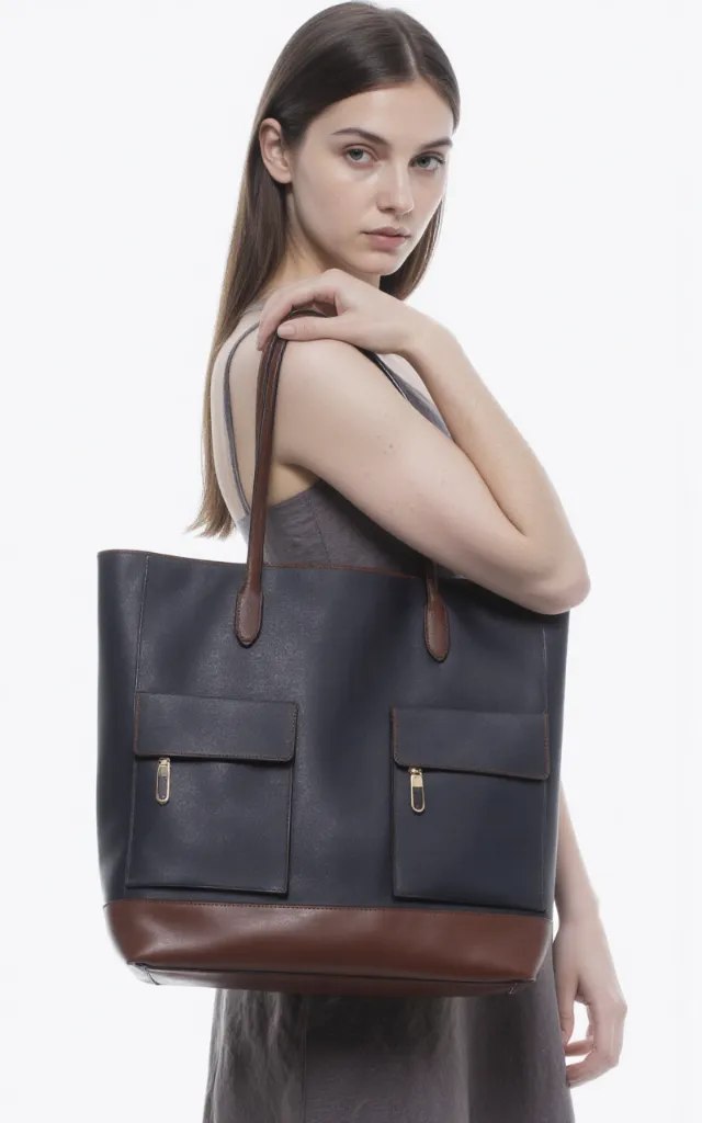 A French female model with a Bag with pockets, wearing a dress, against a white background, in a front   facing close   up